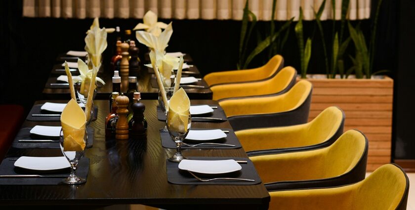 Skyscape Guwahati interior with long table and chairs, one of the best rooftop restaurants in Guwahati.