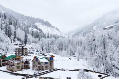 Solang Valley in Manali covered in fresh snow with mountains and pine trees around.