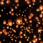Thousands of glowing lanterns light up the sky during the Yi Peng Lantern Festival.