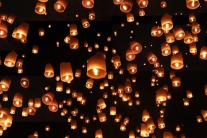Thousands of glowing lanterns light up the sky during the Yi Peng Lantern Festival.